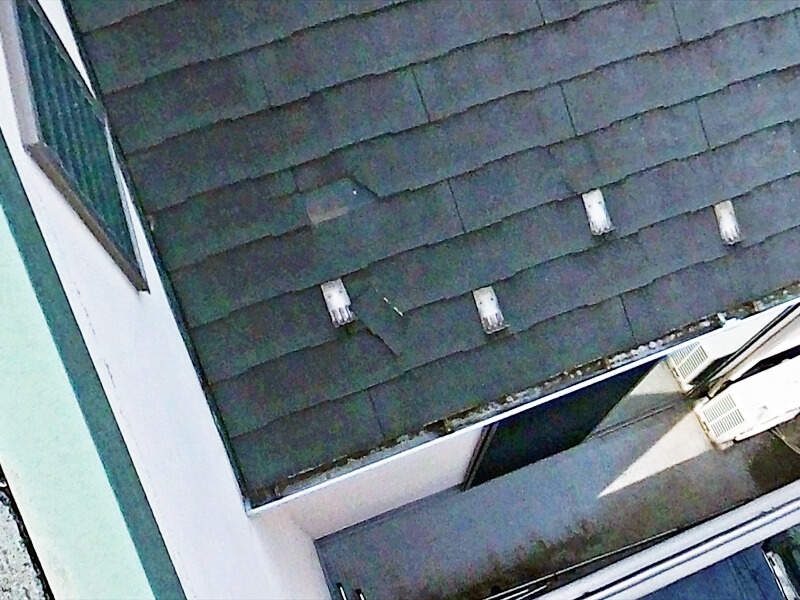 屋根材が割れて、破片が雪止めに引っかかっています。